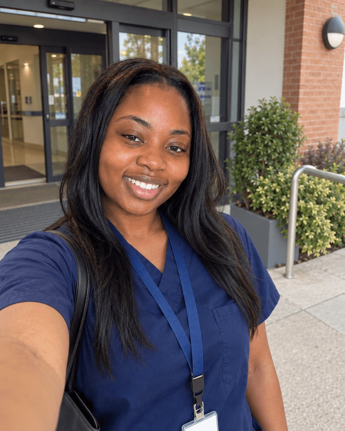 Amara in her care work scrubs outside work